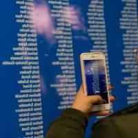 Student taking a picture of their name on I am GV board of nominees